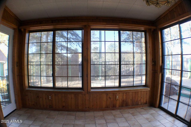 unfurnished sunroom featuring vaulted ceiling