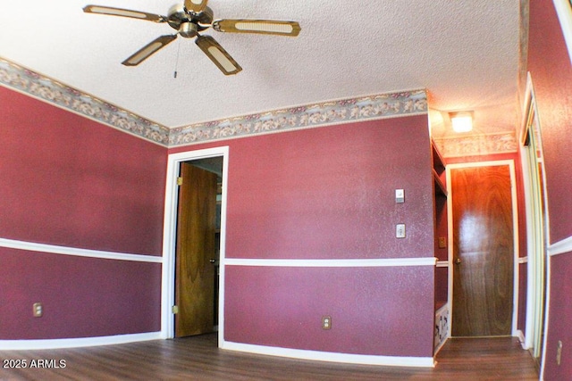 empty room with ceiling fan and hardwood / wood-style floors