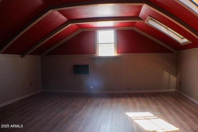 bonus room featuring vaulted ceiling and hardwood / wood-style floors