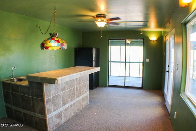 bar with black fridge, ceiling fan, carpet floors, and sink