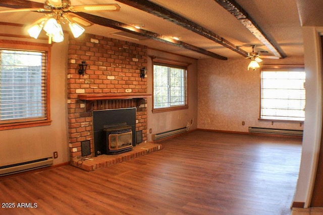 unfurnished living room with beamed ceiling, ceiling fan, hardwood / wood-style flooring, and a baseboard heating unit