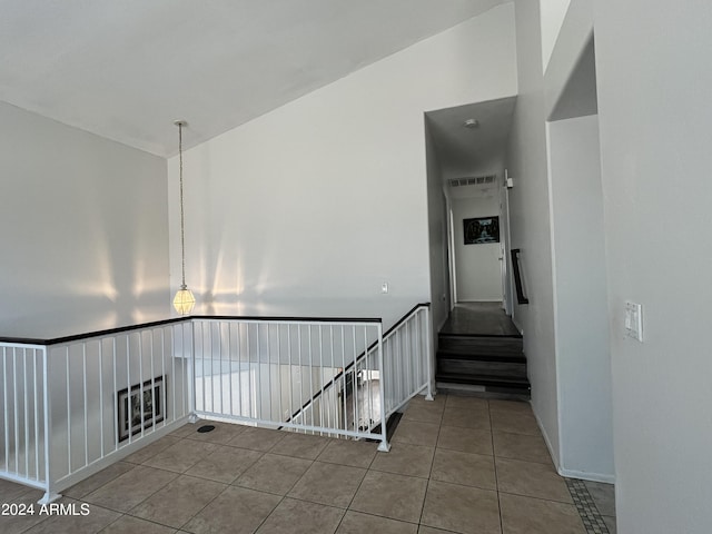 stairs featuring tile patterned floors and lofted ceiling