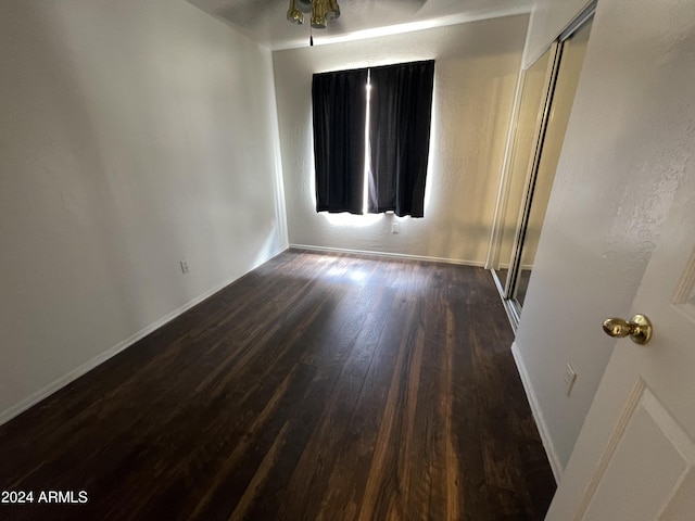 spare room with ceiling fan and dark hardwood / wood-style flooring