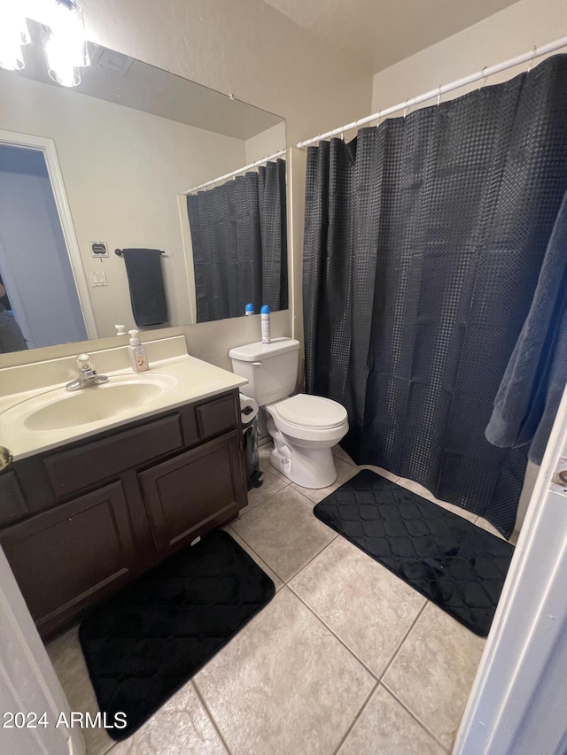 bathroom with tile patterned floors, vanity, and toilet