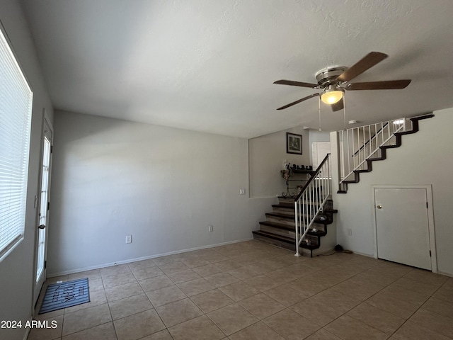 unfurnished room featuring ceiling fan and light tile patterned flooring