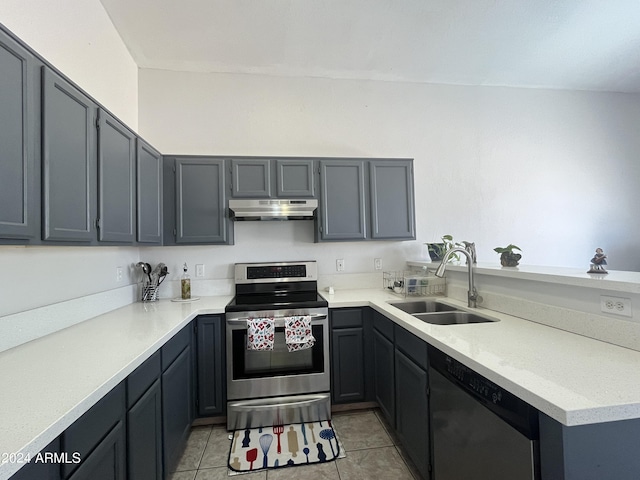 kitchen featuring light tile patterned floors, stainless steel appliances, gray cabinets, and sink