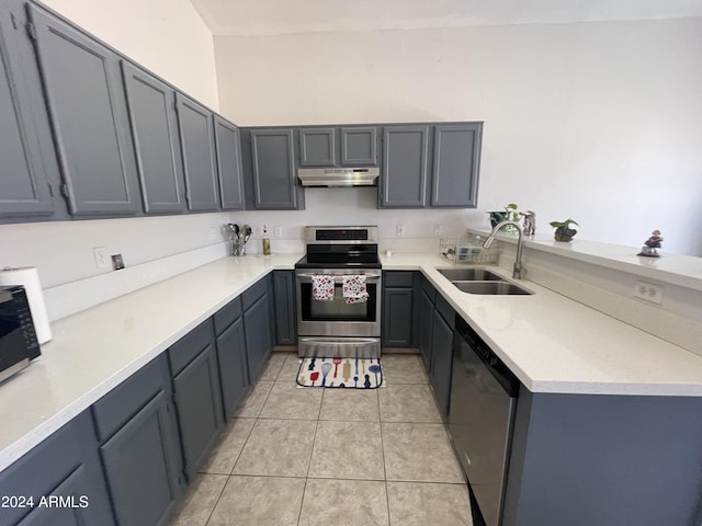 kitchen with gray cabinets, light tile patterned floors, sink, and appliances with stainless steel finishes