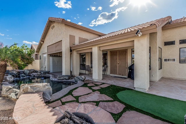 2535 N Pinnule Cir, Mesa, AZ 85215 - rear view of property with stucco siding, a tile roof, a patio, and an attached garage