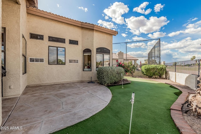 2535 N Pinnule Cir, Mesa, AZ 85215 - view of yard with an area to practice putting, fence, and a patio