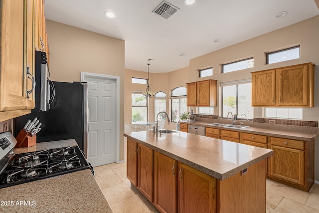 2535 N Pinnule Cir, Mesa, AZ 85215 - kitchen with a sink, appliances with stainless steel finishes, a center island with sink, brown cabinets, and recessed lighting