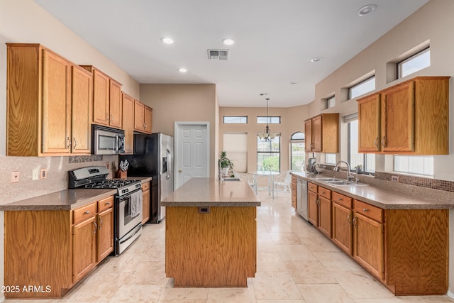 2535 N Pinnule Cir, Mesa, AZ 85215 - kitchen featuring stainless steel appliances, a sink, a center island with sink, tasteful backsplash, and recessed lighting