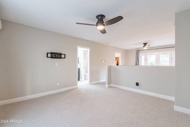 empty room with ceiling fan and light carpet