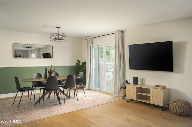 dining space with hardwood / wood-style flooring