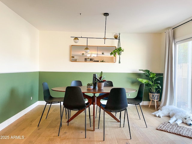 dining space with wood-type flooring