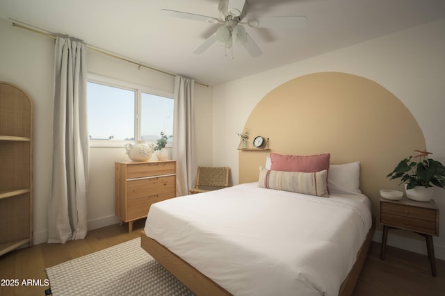 bedroom with dark hardwood / wood-style floors and ceiling fan