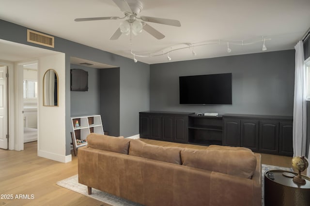 living room featuring light hardwood / wood-style flooring, ceiling fan, and track lighting