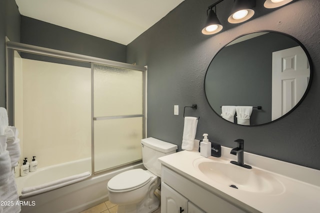 full bathroom with vanity, tile patterned flooring, bath / shower combo with glass door, and toilet