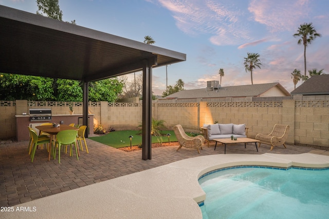 pool at dusk featuring an outdoor living space, a patio, central AC, and grilling area