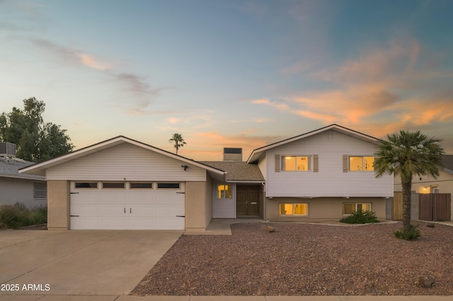 view of front of house featuring a garage and cooling unit