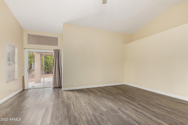 empty room featuring baseboards, vaulted ceiling, wood finished floors, and a ceiling fan