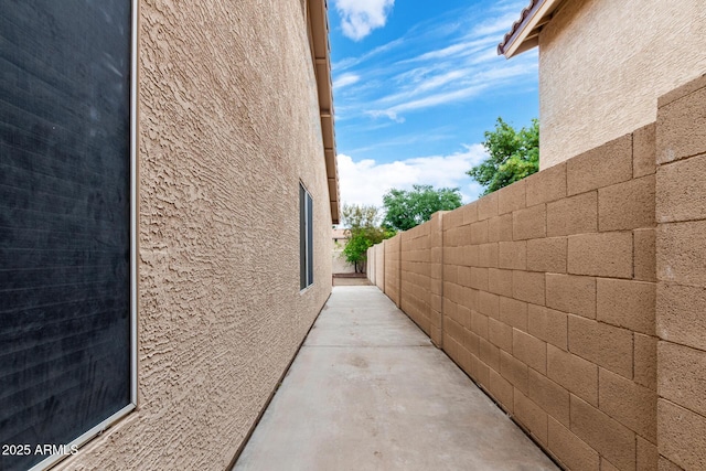 view of home's exterior featuring stucco siding and fence