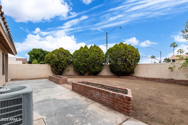 view of patio with cooling unit and a fenced backyard