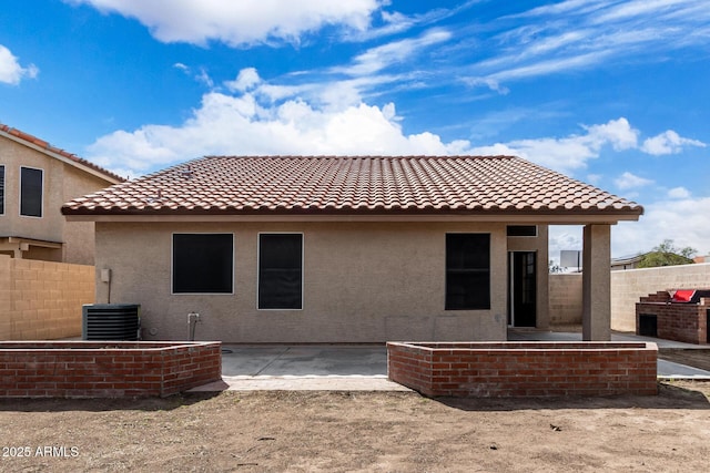back of house featuring a tile roof, stucco siding, central air condition unit, fence, and a patio