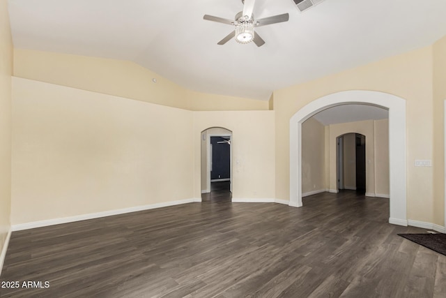 unfurnished room featuring dark wood finished floors, arched walkways, vaulted ceiling, and ceiling fan