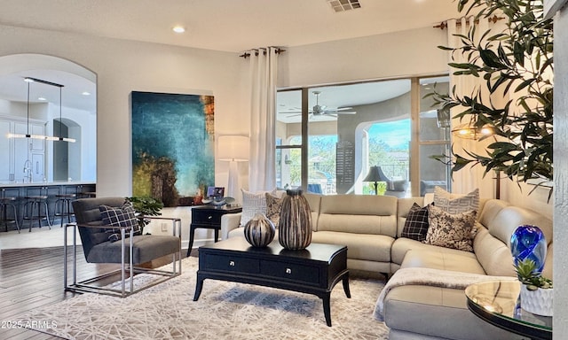 living area featuring ceiling fan, wood finished floors, and recessed lighting