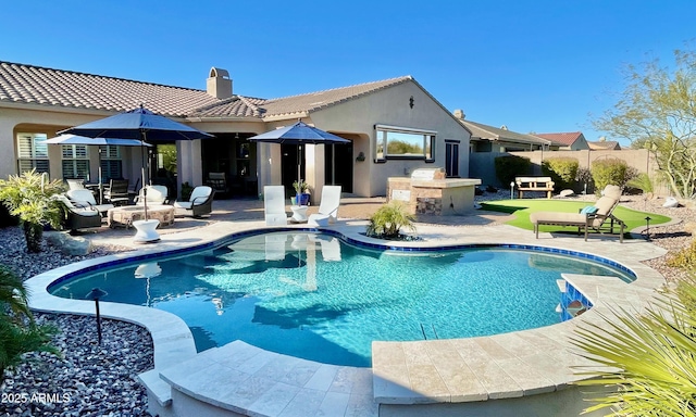 rear view of house featuring a patio area, a chimney, an outdoor bar, and fence