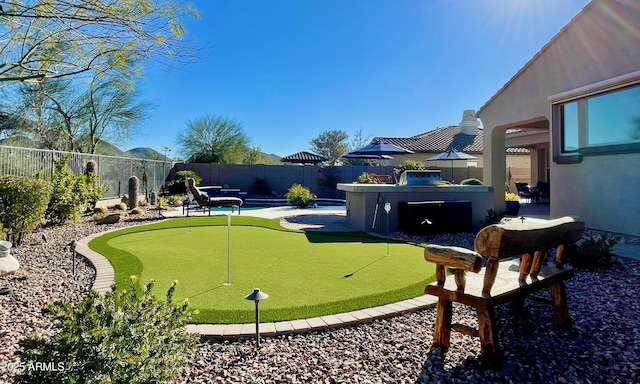 view of home's community featuring a pool, a fenced backyard, and a hot tub