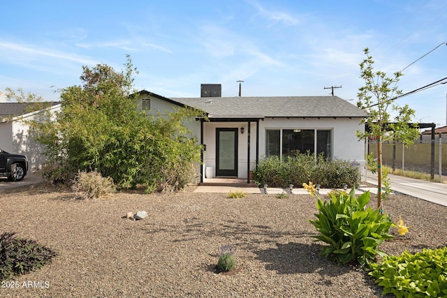 1615 E Roma Ave, Phoenix, AZ 85016 - view of front facade featuring stucco siding, a shingled roof, and fence