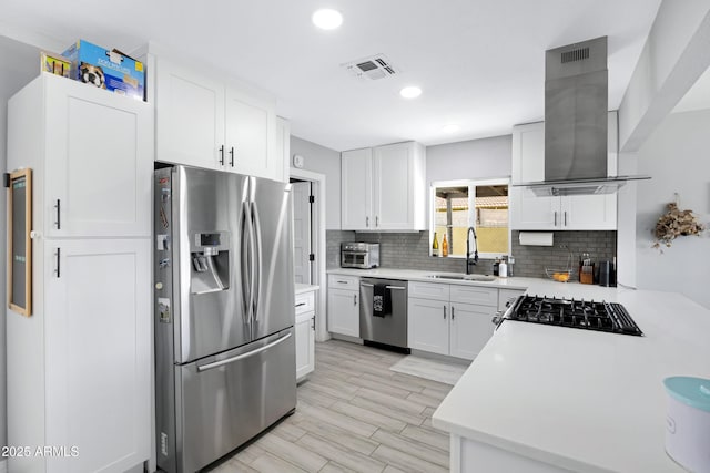 1615 E Roma Ave, Phoenix, AZ 85016 - kitchen featuring appliances with stainless steel finishes, a sink, wall chimney range hood, decorative backsplash, and light countertops