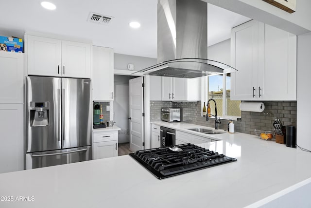 1615 E Roma Ave, Phoenix, AZ 85016 - kitchen featuring stainless steel fridge, island range hood, a sink, black stovetop, and backsplash