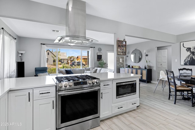 1615 E Roma Ave, Phoenix, AZ 85016 - kitchen with stainless steel appliances, open floor plan, island range hood, and light countertops