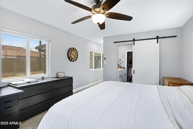 1615 E Roma Ave, Phoenix, AZ 85016 - bedroom with a barn door, light wood finished floors, and a ceiling fan