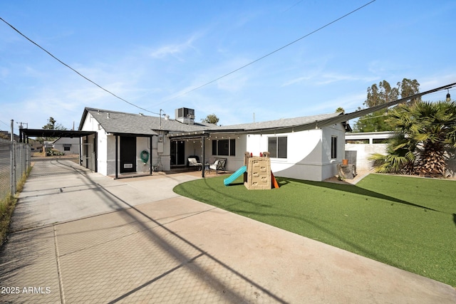 1615 E Roma Ave, Phoenix, AZ 85016 - back of house with fence, central air condition unit, a playground, and stucco siding
