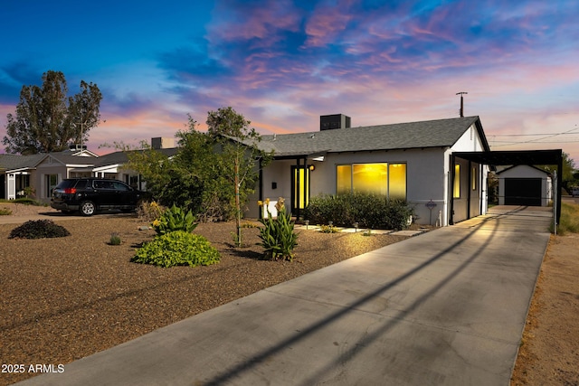 1615 E Roma Ave, Phoenix, AZ 85016 - view of front of property with concrete driveway, stucco siding, a carport, a shingled roof, and a chimney