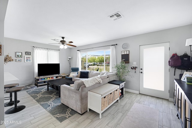 1615 E Roma Ave, Phoenix, AZ 85016 - living area featuring wood tiled floors, a ceiling fan, and baseboards