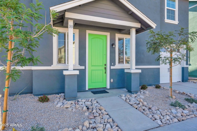doorway to property featuring stucco siding