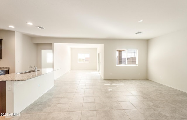 5029 S 252nd Ave, Buckeye, AZ 85326 - unfurnished room with healthy amount of natural light, light tile patterned floors, a sink, and recessed lighting