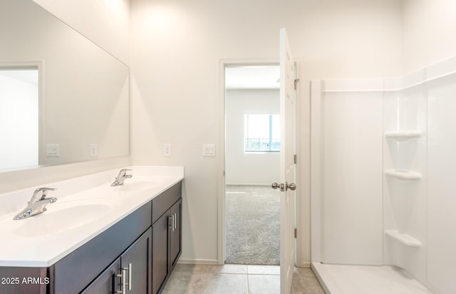 5029 S 252nd Ave, Buckeye, AZ 85326 - bathroom with double vanity, tile patterned floors, baseboards, and a shower