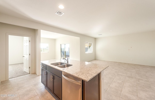 5029 S 252nd Ave, Buckeye, AZ 85326 - kitchen with stainless steel dishwasher, a sink, light tile patterned floors, open floor plan, and a center island with sink