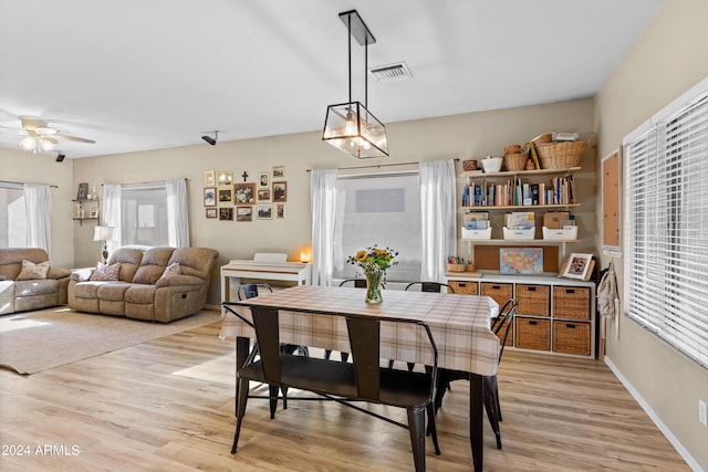 dining area featuring light wood-type flooring, ceiling fan, and a healthy amount of sunlight