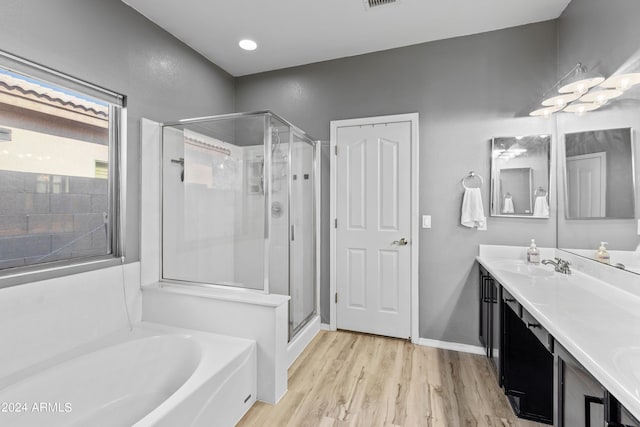 bathroom with shower with separate bathtub, vanity, and hardwood / wood-style flooring