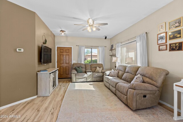 living room with ceiling fan and light hardwood / wood-style floors