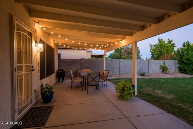 patio terrace at dusk with a lawn