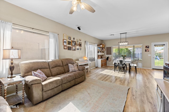 living room featuring light hardwood / wood-style flooring and ceiling fan