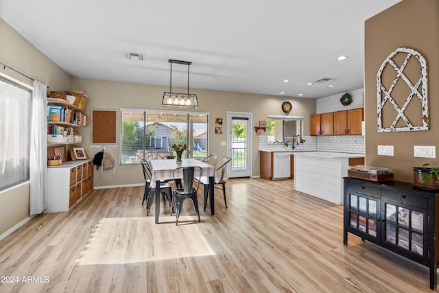 dining area with light hardwood / wood-style flooring and sink