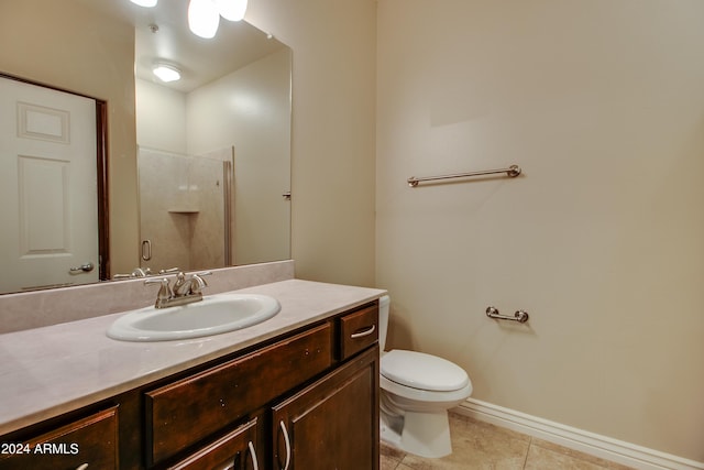 bathroom with toilet, vanity, tile patterned floors, and a shower with shower door